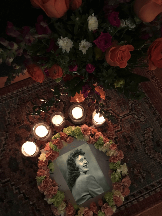 photo of my mother surrounded by flowers and candles