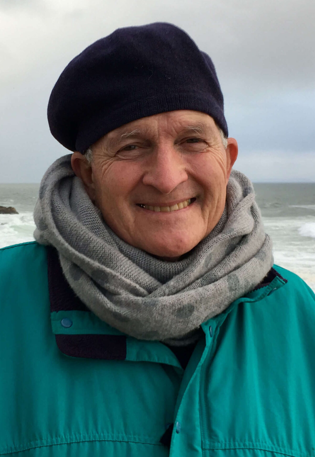 photo of Sheila's husband Wes who is smiling with the ocean behind him